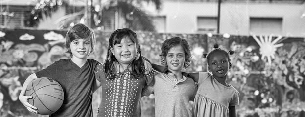 Elementary school children playing basketball at gym