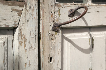 Metal door handle in old wooden door