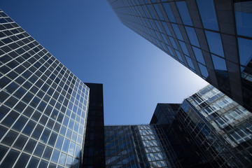Fototapeta premium Skyscrapers with glass facade. Modern buildings in Paris business district. Concepts of economics, financial, future. Copy space for text. Dynamic composition.