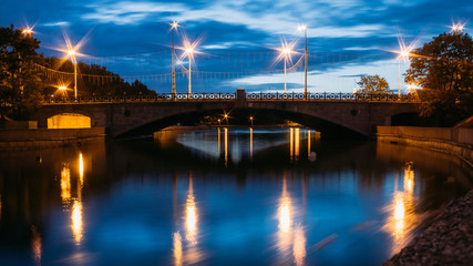 Fototapeta na wymiar Night View Of River And Bridge In Minsk, Belarus