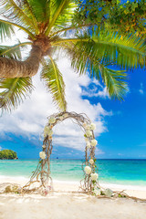 Wedding on the beach . Wedding arch decorated of vines and flowe