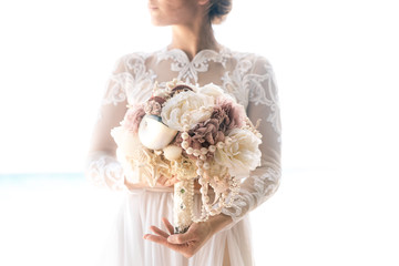 Beautiful brunette fiancee in white wedding dress with big long