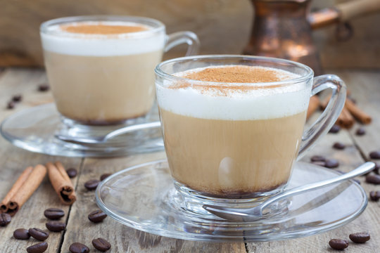 Coffee latte with cinnamon in glass cups