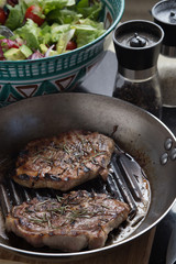 Steak cooking on grille pan. Fresh, delicious, spicy meat on a kitchen with copy space closeup