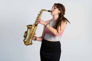 Girl with dreadlocks playing the saxophone