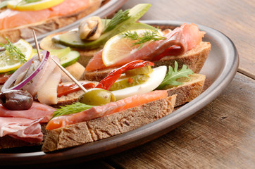 Open sandwiches with salmon, eggs, mussels, jamon and herring