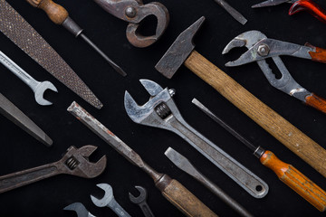 Construction tools set on dark background. Assortment instruments for repairman, carpenter, builder. Copy space for text. Top view. 