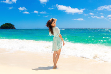 Fototapeta na wymiar Young beautiful Asian girl on the tropical beach