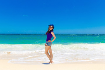 Fototapeta na wymiar Young beautiful Asian girl on a tropical beach. Summer vacation