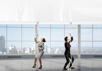 Fototapeta premium Businesspeople pulling banner