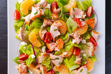 Fresh Orange Salmon salad with honey, tomatoes, onion, mandarin. healthy