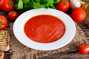 Smooth and sweet tomato soup, seasoned with basil, garlic