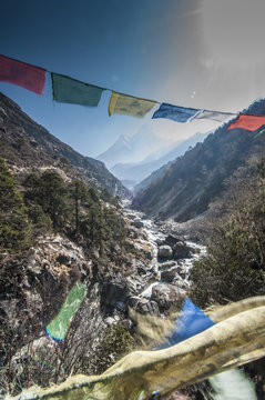 Prayer flags from bridge with Mt.Ama Dablam in background