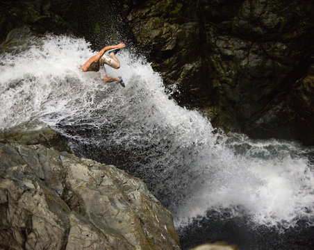 Man jumping in to waterfall, Lynn Canyon, Vancouver, Canada