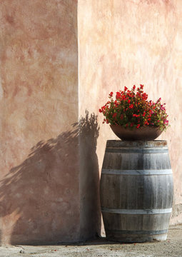 Flower pot on an old wine barrel in winery