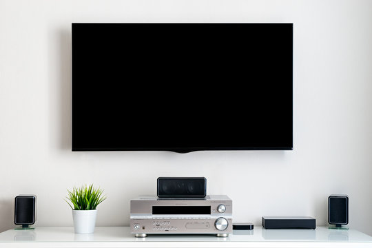 Home Multimedia Center - Flat Tv With Blank Black Screen On Wall And Acoustic System In Residential Room Interior