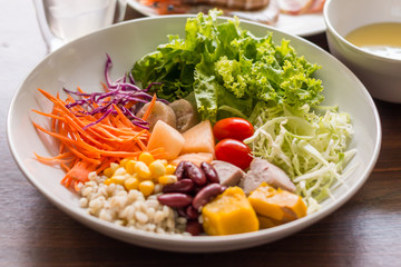 Mixed salad with tomatoes, corn, carrots, cantaloupe, red beans,