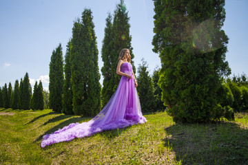Young woman in beautiful dress amongst trees