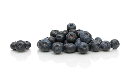 ripe blueberries on a white background with reflection