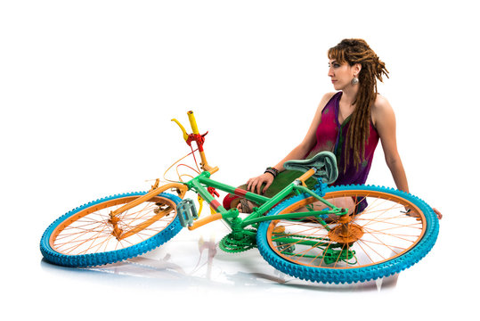 Girl with dreadlocks on colorful bike