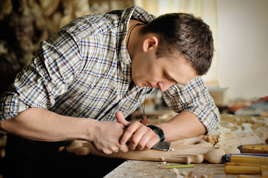 Carver in workshop of wood carving