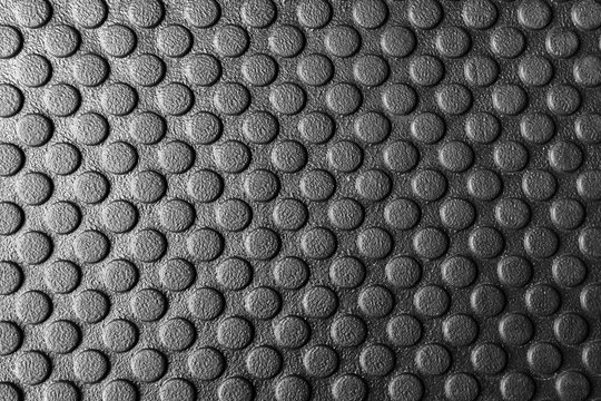 The rubber mats,the rubber mats with the round pattern texture for anti slip.The round pattern texture on the rubber mats.Close-up of rubber mats texture with round pattern in black and white scene.