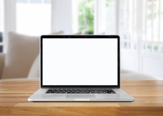 Laptop with blank screen on table. interior background