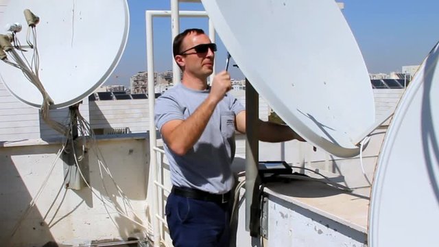 Technician correct installation  of satellite dish