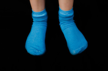 Close up of childs feet wearing blue cotton socks