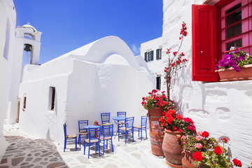 Traditional greek street with flowers in Amorgos island, Greece - obrazy, fototapety, plakaty