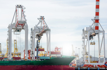 Fototapeta premium Logistic Import Export background, Port cranes working in sea port, Crane of freight dock,Container Cargo freight ship with working crane bridge in shipyard.
