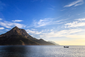 Fishing boat in the sea. Motion blur special effect. Sunrise scene.