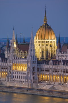 The neo-gothic Hungarian Parliament building, designed by Imre Steindl, illuminated at night, and the River Danube, Budapest, Hungary