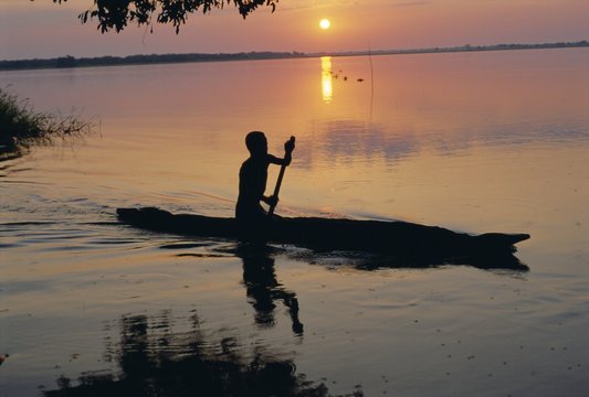 Anouak man in canoe, Lake Tata, Ethiopia