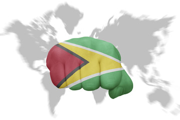 fist with the national flag of guyana on a world map background