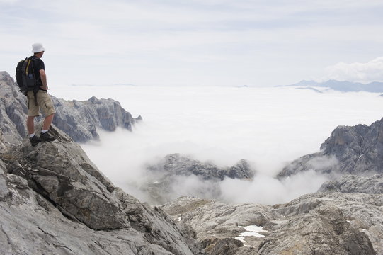 Hiker on Tesorero Peak, Picos de Europa National Park, shared by the provinces of Asturias, Cantabria and Leon, Spain