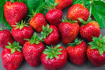Fresh strawberries. Red strawberry and green leaves.