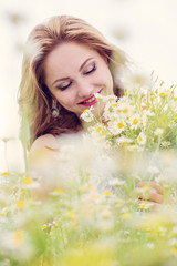 young woman with a bouquet of field daisies