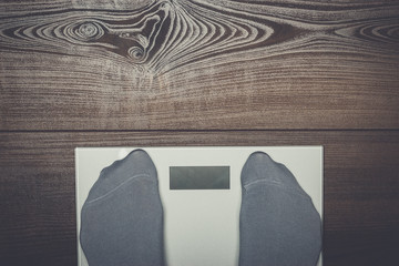 grey electronic scales on the wooden floor