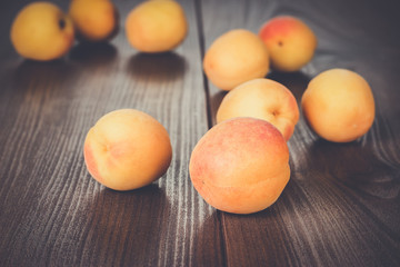 some fresh apricots over brown wooden background