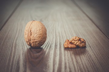 three walnuts on the brown wooden table background