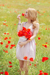 Naklejka na ściany i meble Young woman with long hair in poppies