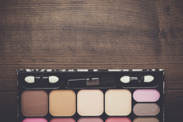 white make-up brushes on brown wooden background