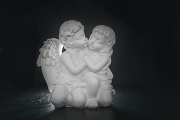 figurine of angels on a black background with backlight