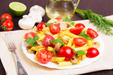 Classic Italian food - pasta with mushrooms, tomatoes and parsley on a dark wooden background