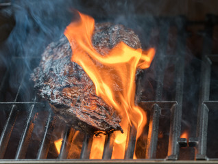 Large fillet of beef flaming on barbeque