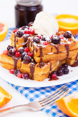 Belgian waffles with berries, ice cream and chocolate sauce