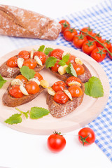 Classic italian bruschetta with tomatoes and garlic on a board