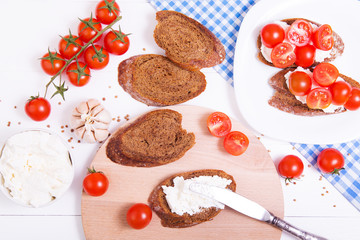 Cooking italian bruschetta with cheese and tomatoes on the wooden background
