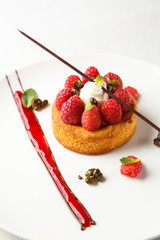 Sable breton or  shortbread with vanilla cream and raspberry coulis on white dish